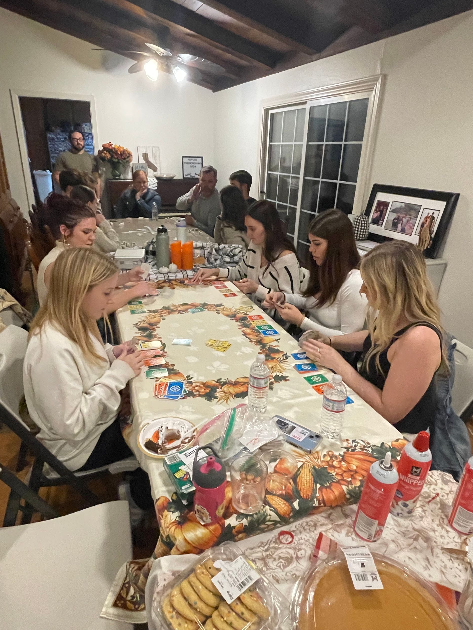 A group of people are sitting around a long table.