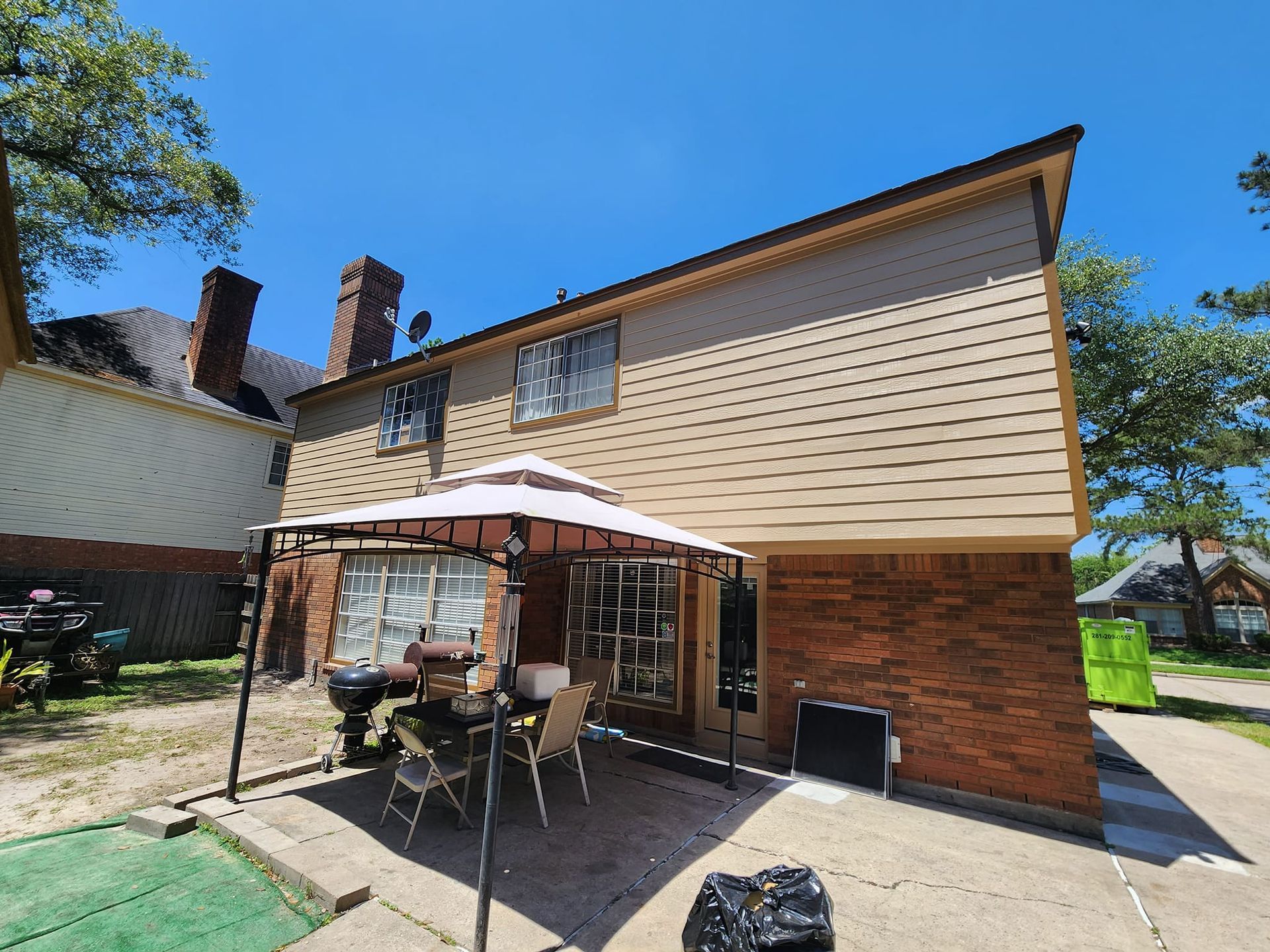 A large brick house with a gazebo in front of it.