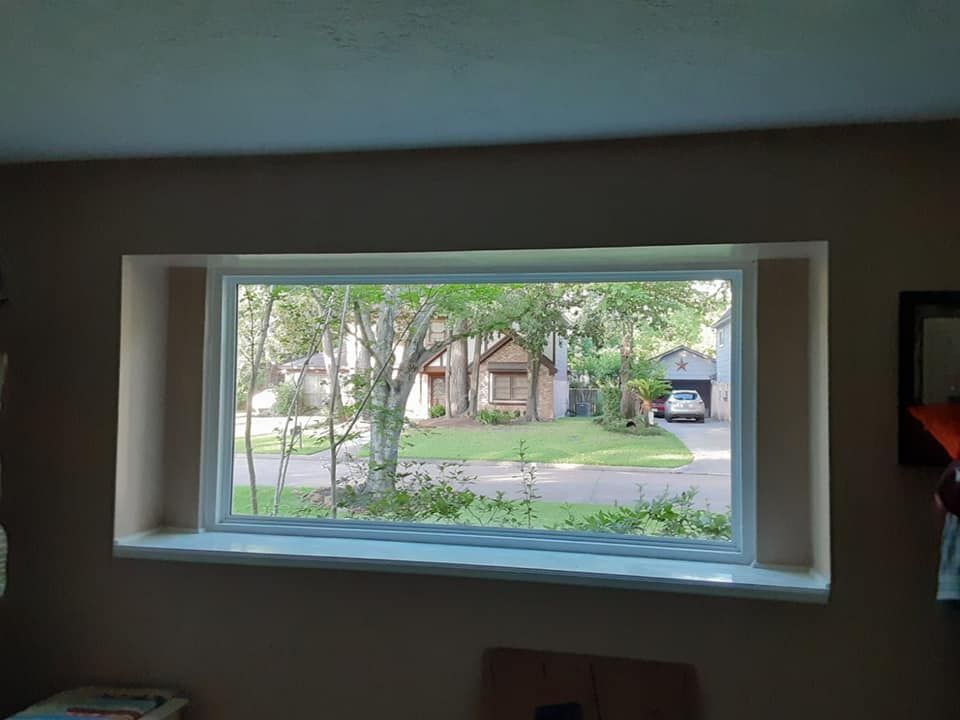 A large window with a view of a residential neighborhood