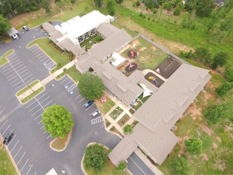Certainteed Landmark in Sunrise Cedar, and the flat, white roof is Versico 60 mil TPO Single Ply Roofing Membrane. Trinity Lutheran Church in Athens, GA