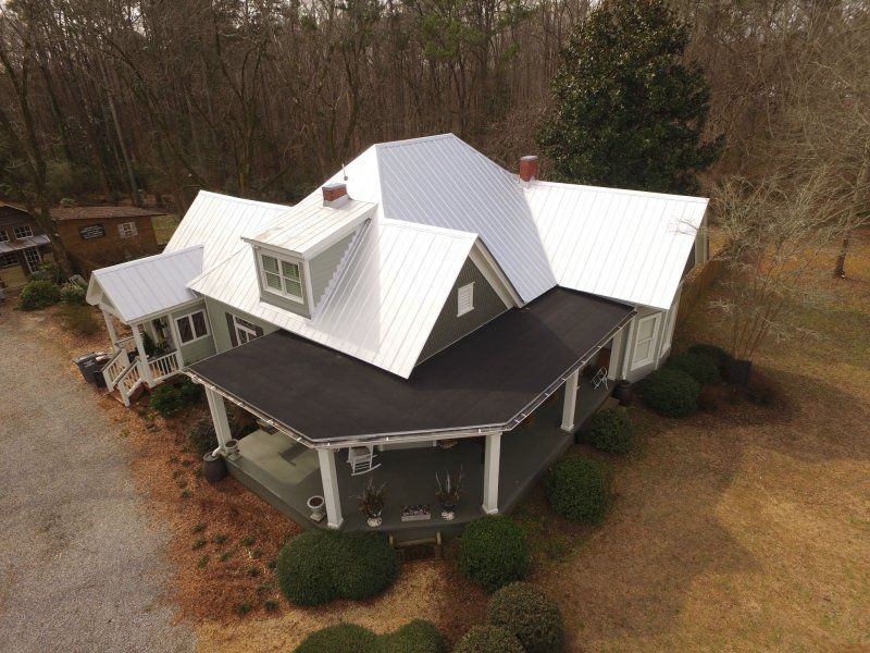 Historic hone in Bogart, GA. Removed the old, rusty metal, installed all new plywood decking, synthetic underlayment and new 26 gauge 5V metal with a Galvalume (silver) finish. Replaced the 2 large slope porch roofs with 2 layer self-adhered modified bitumen roofing systems.