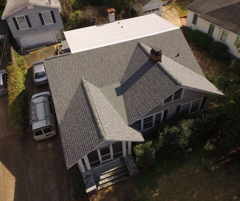 Certainteed Landmark  Lifetime Architectural Shingle in Pewter and on the low slope upper roof an energy efficient, white certainteed Flintalstic Self-Adhered Modified Bitumen Roofing System