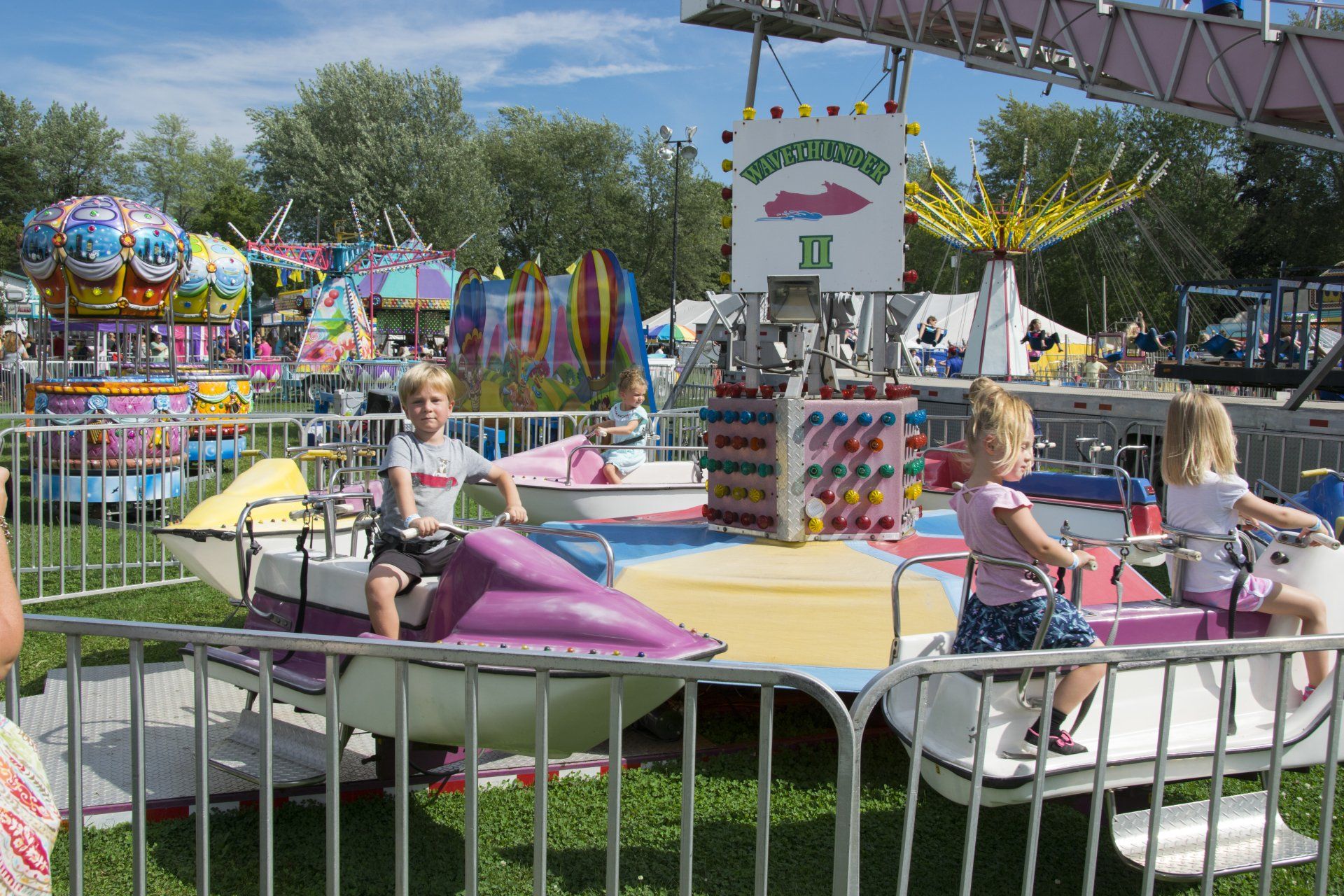 Children ride a merry go round at an amusement park