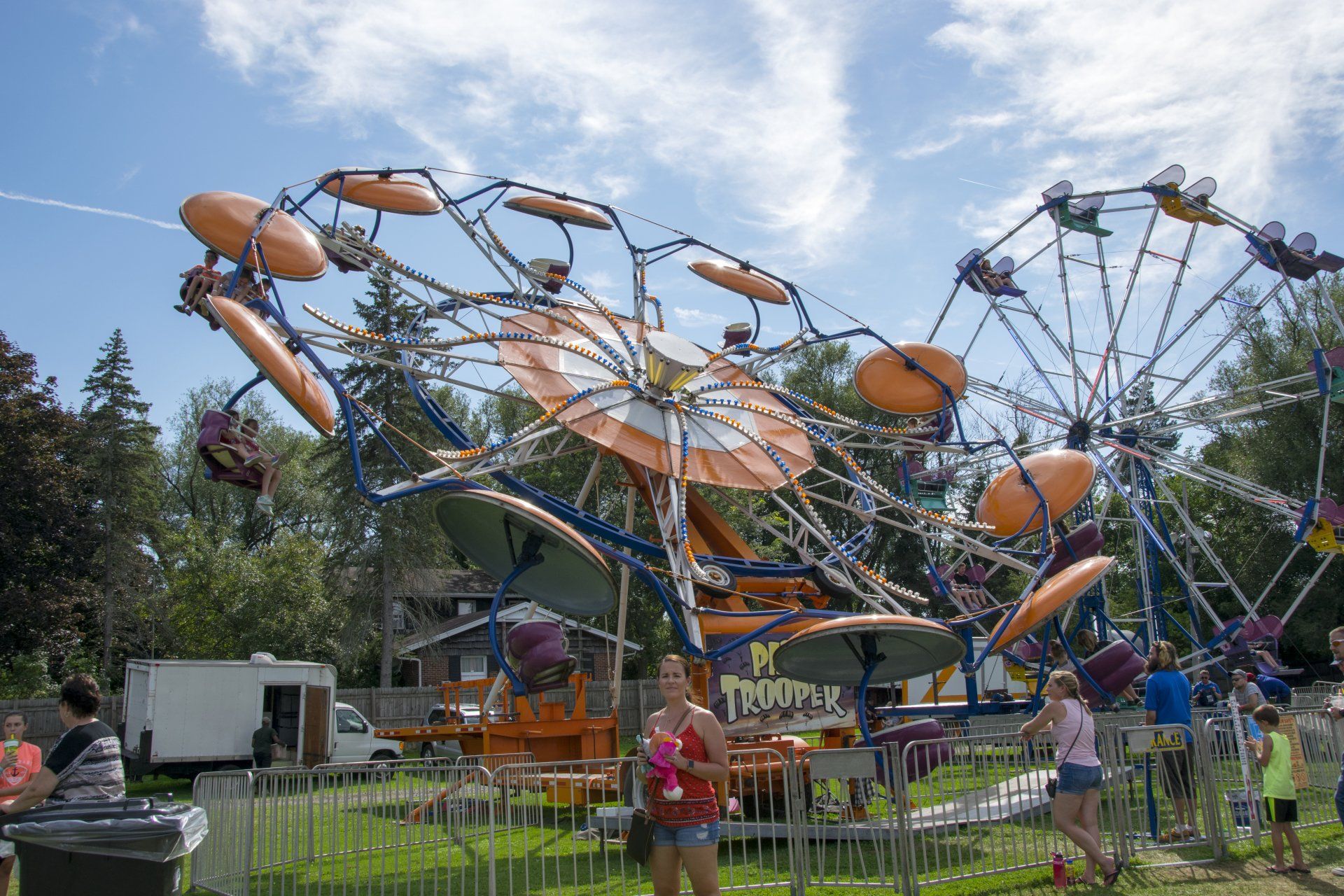 A ferris wheel at a carnival with people riding it