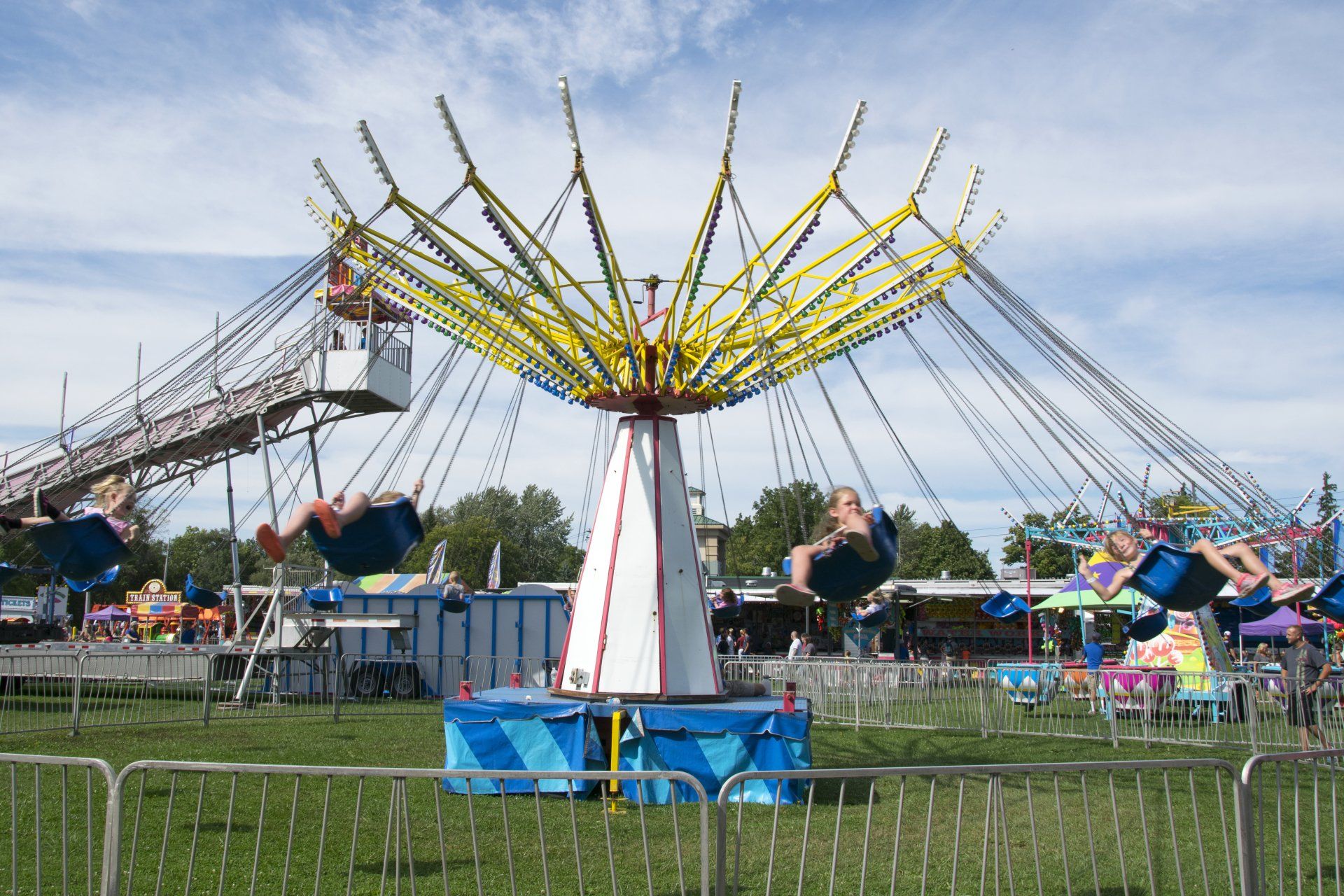 People are riding a swing ride at an amusement park
