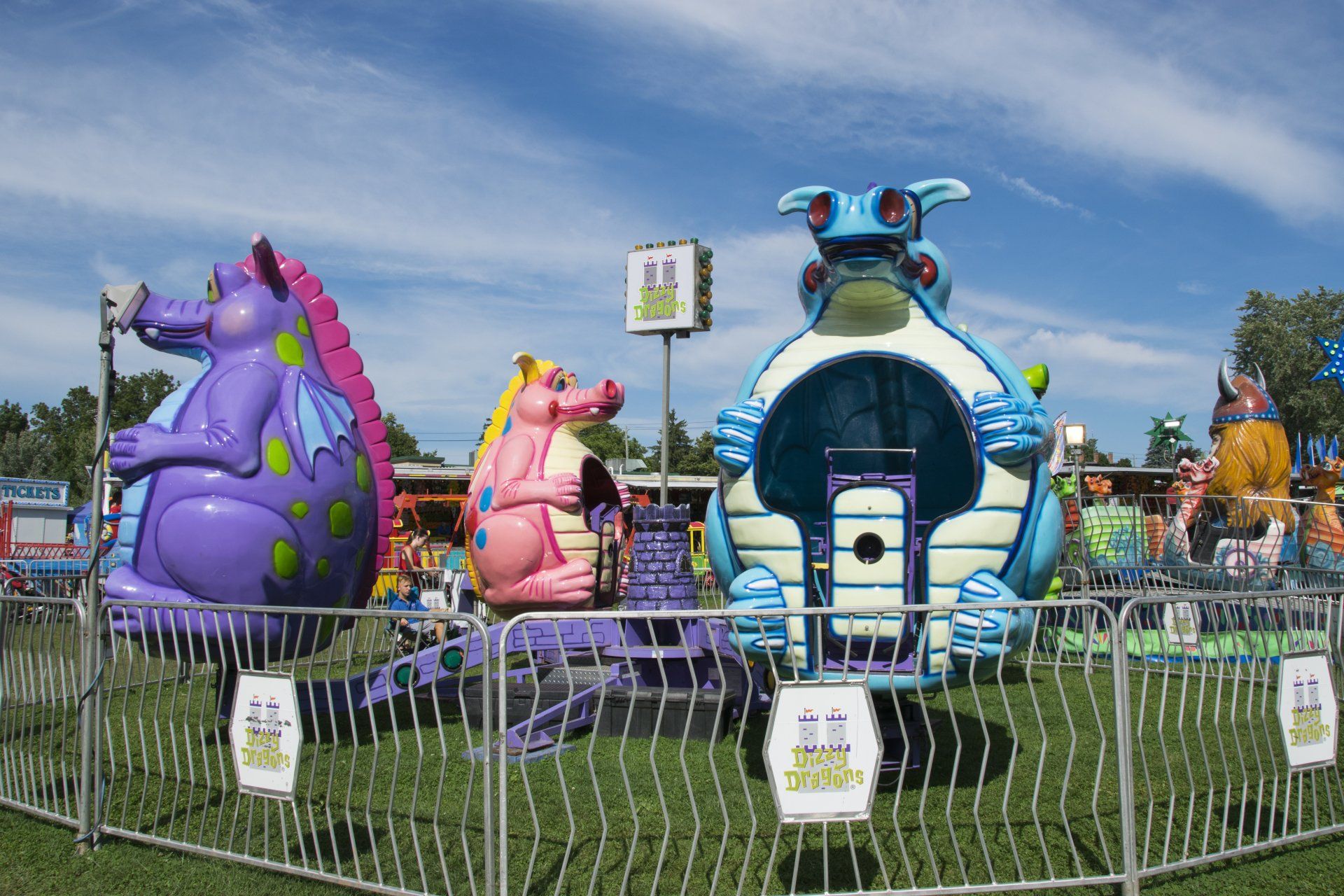 A carnival ride with a purple dragon and a blue frog