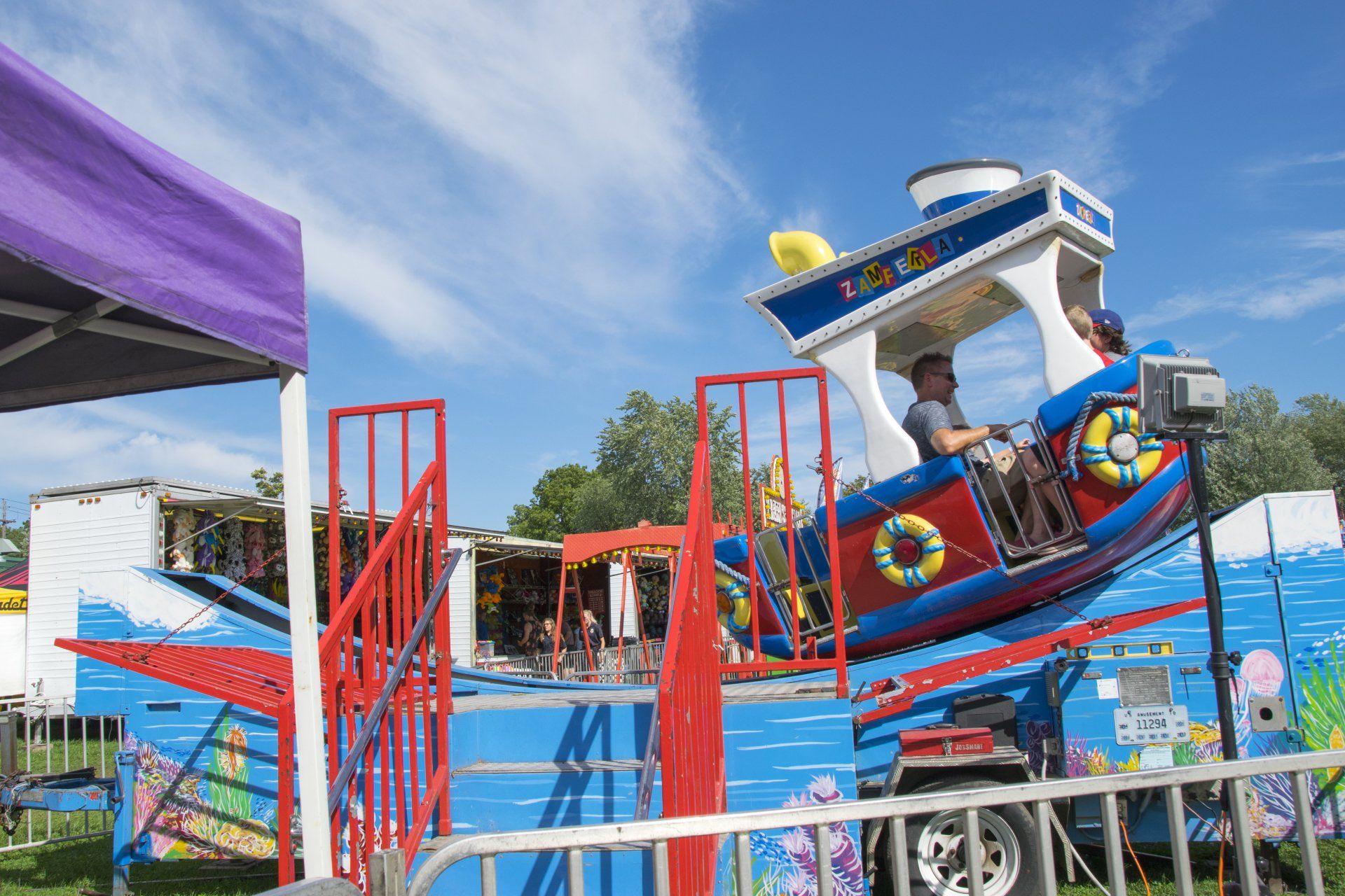 People are riding a carnival ride that says catch