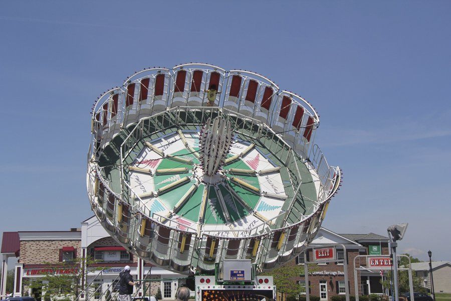 A ferris wheel with a sign that says ' s & t ' on it
