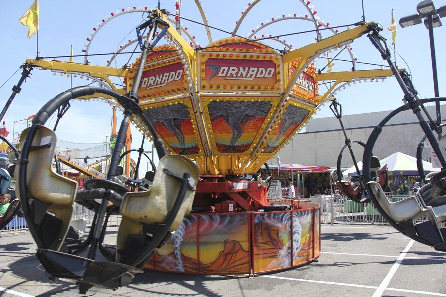 A carnival ride that says tornado on it