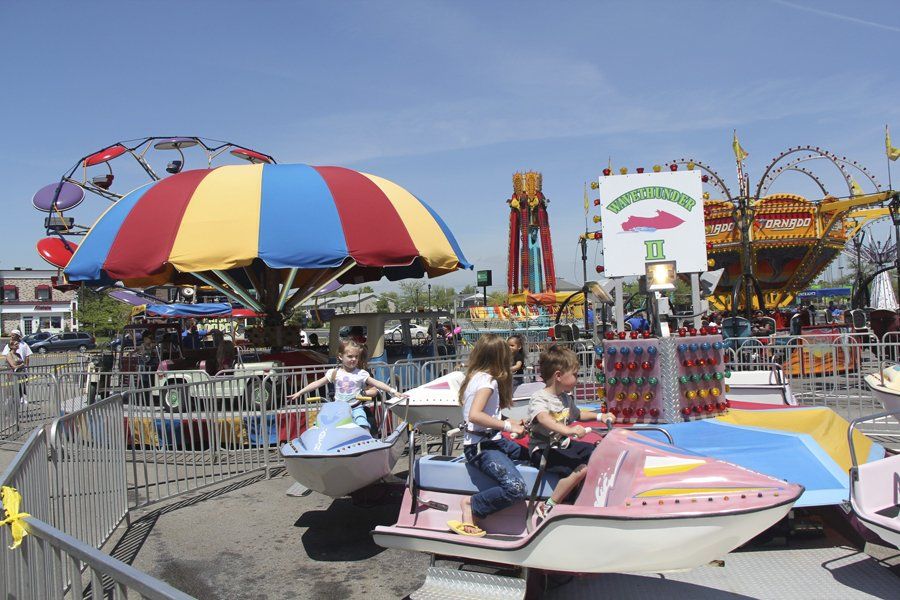 A carnival ride with a sign that says ' mickey mouse ' on it