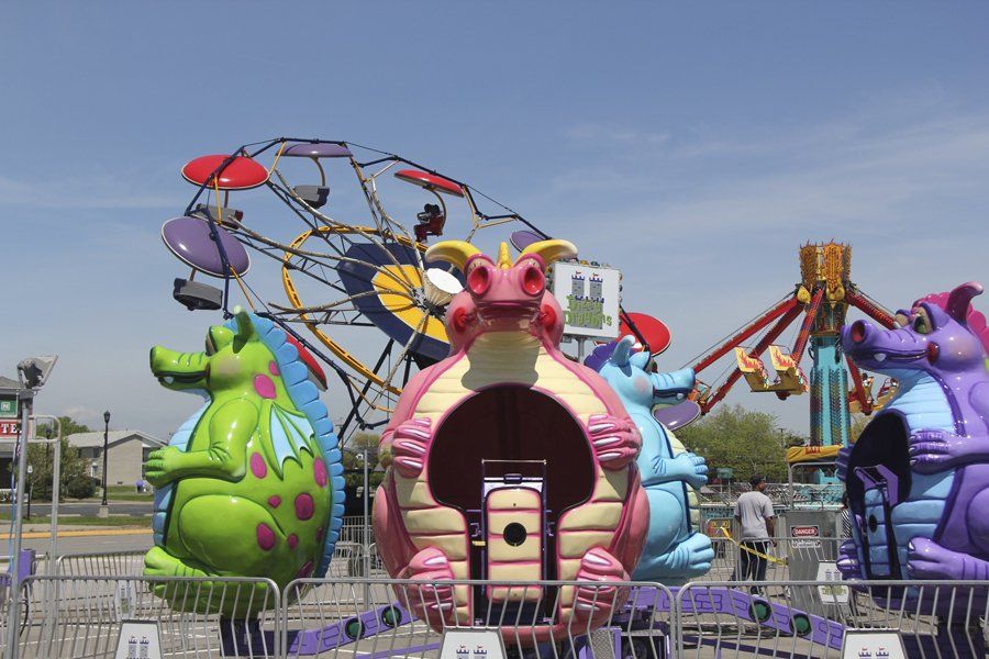 An amusement park with a ferris wheel and a dragon ride