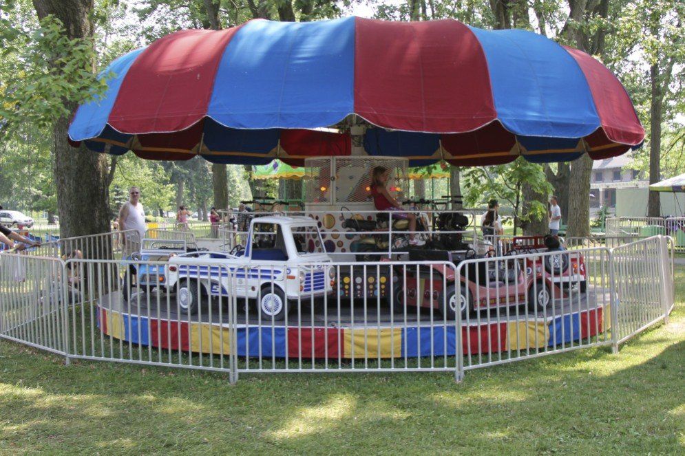 A merry go round with a police car on it