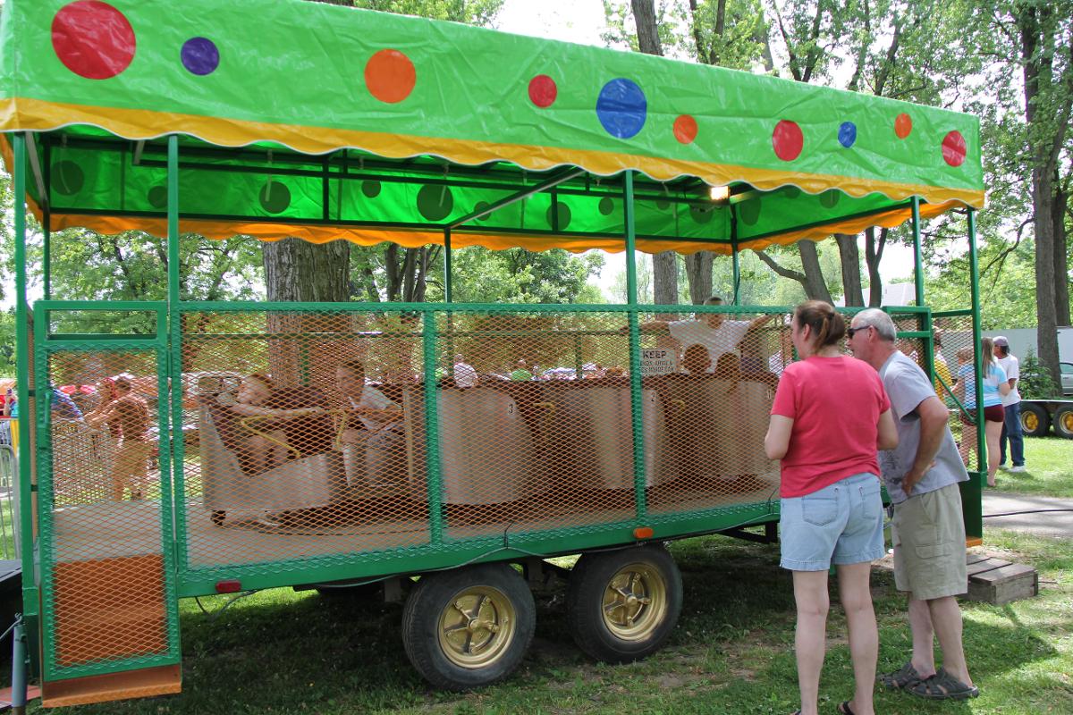 People looking at a green trailer with polka dots on it