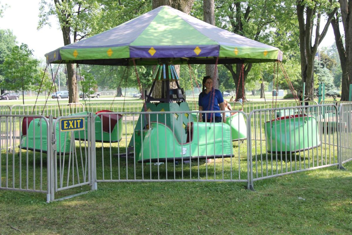 A carousel in a park with a sign that says exit