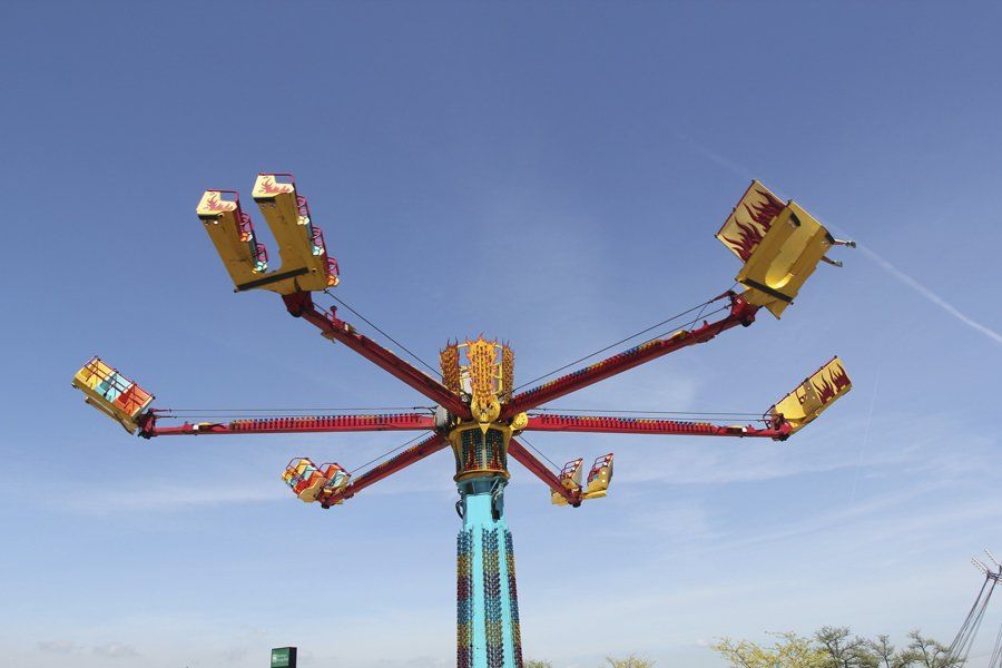 A carnival ride with a blue sky in the background