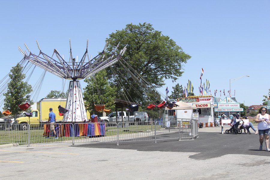A carnival with a truck that says ' snack ' on it
