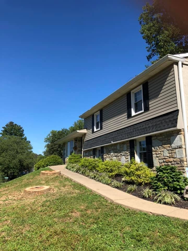 A house with a walkway leading to it and a fire pit in front of it.