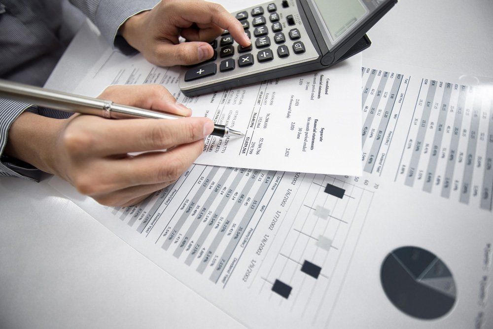 Bookkeeper Entering Data into Calculator — Business Assistance in Bundaberg QLD
