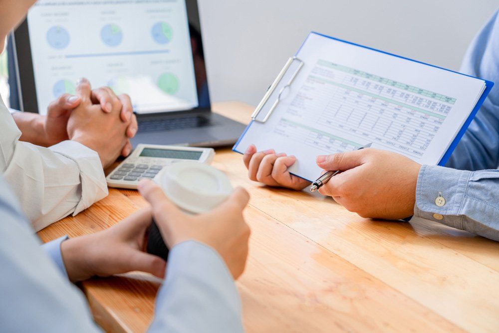 Bookkeeper going over Financial Information with Clients — Bookkeeping in Bundaberg QLD