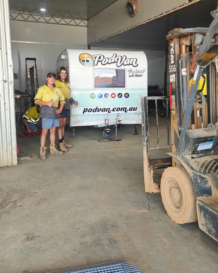A Man Is Welding A Piece Of Metal In A Dark Room — Agriweld Engineering in Dubbo, NSW
