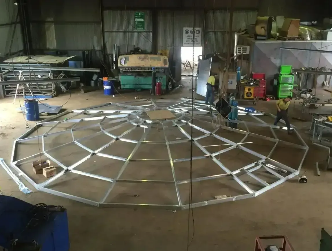 A Large Metal Structure Is Being Built In A Warehouse — Agriweld Engineering in Dubbo, NSW