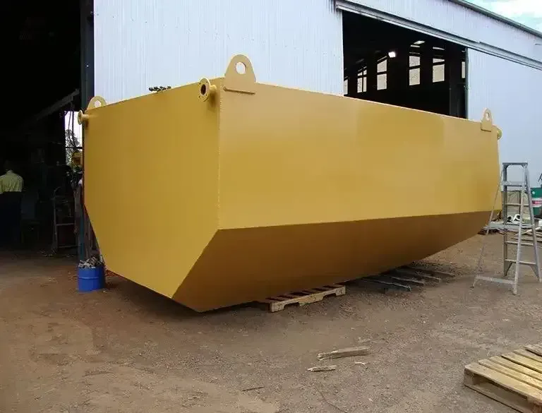 A Large Yellow Dumpster Is Sitting In Front Of A Building — Agriweld Engineering in Dubbo, NSW