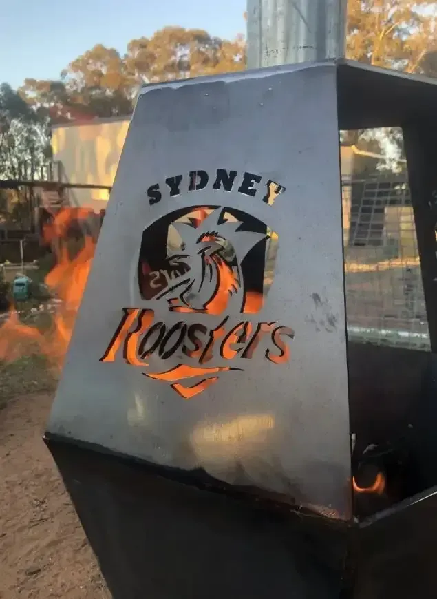 A Sydney Rooster's Fire Pit With Flames Coming Out Of It — Agriweld Engineering in Dubbo, NSW