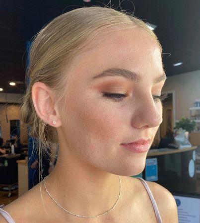 Makeup Artist Applying Eyeshadow To A Woman's Closed Eyes — Gina T Hair & Beauty In Mackay, QLD