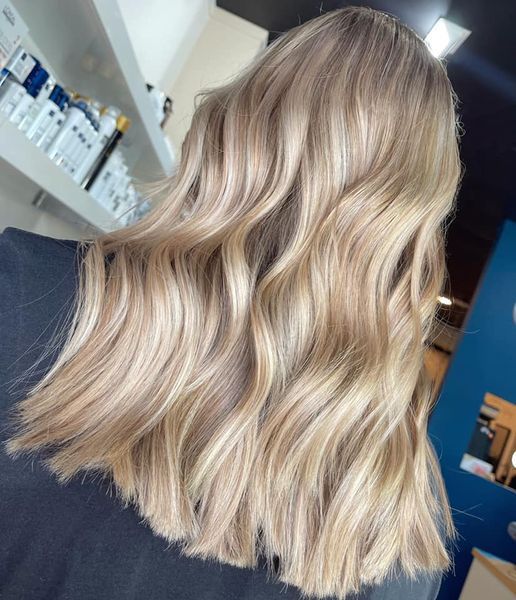 Wavy Blonde Hair With Highlights Cascading Down — Gina T Hair & Beauty In Mackay, QLD