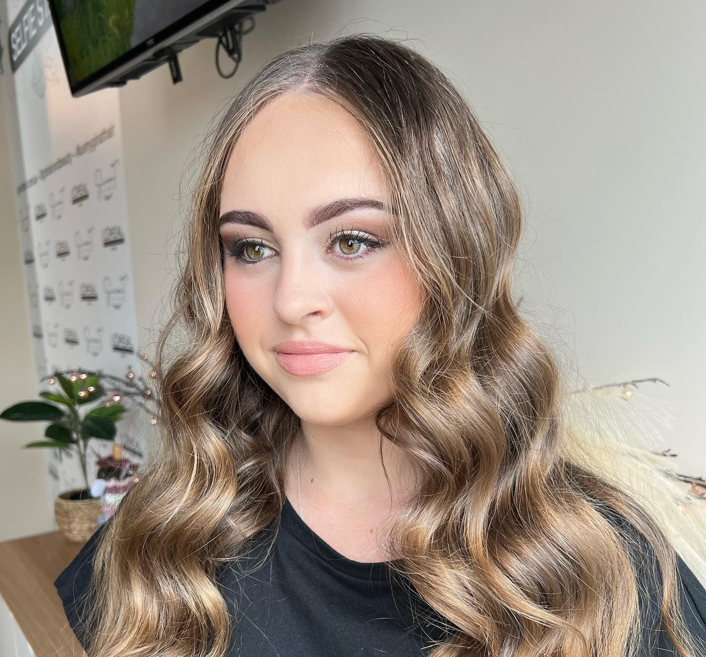 Woman With Dark, Wavy Hair And Makeup At A Salon; She Is Looking At The Camera — Gina T Hair & Beauty In Mackay, QLD