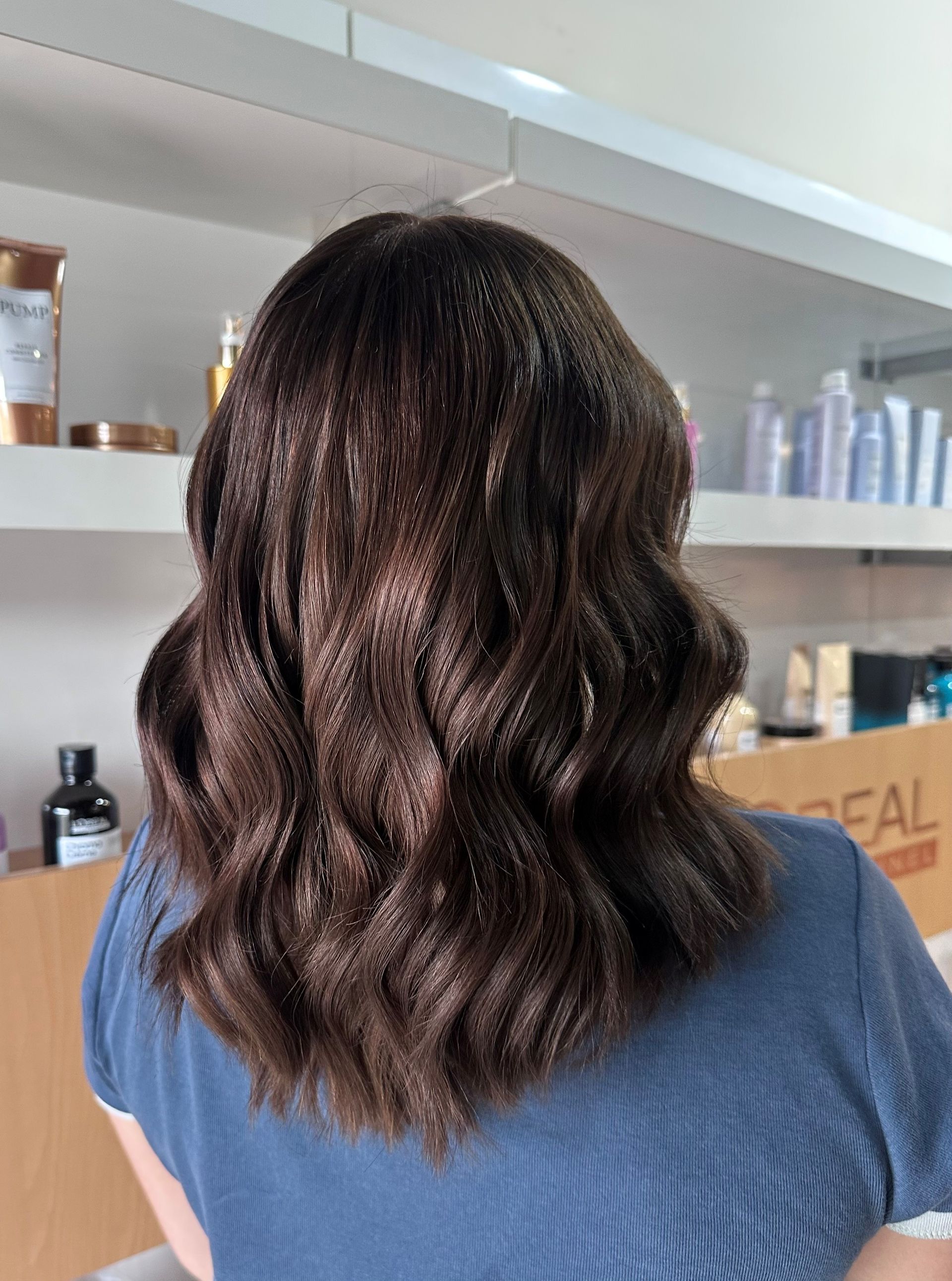 Woman With Wavy, Highlighted Blonde Hair; Back View Against A Neutral Wall — Gina T Hair & Beauty In Mackay, QLD