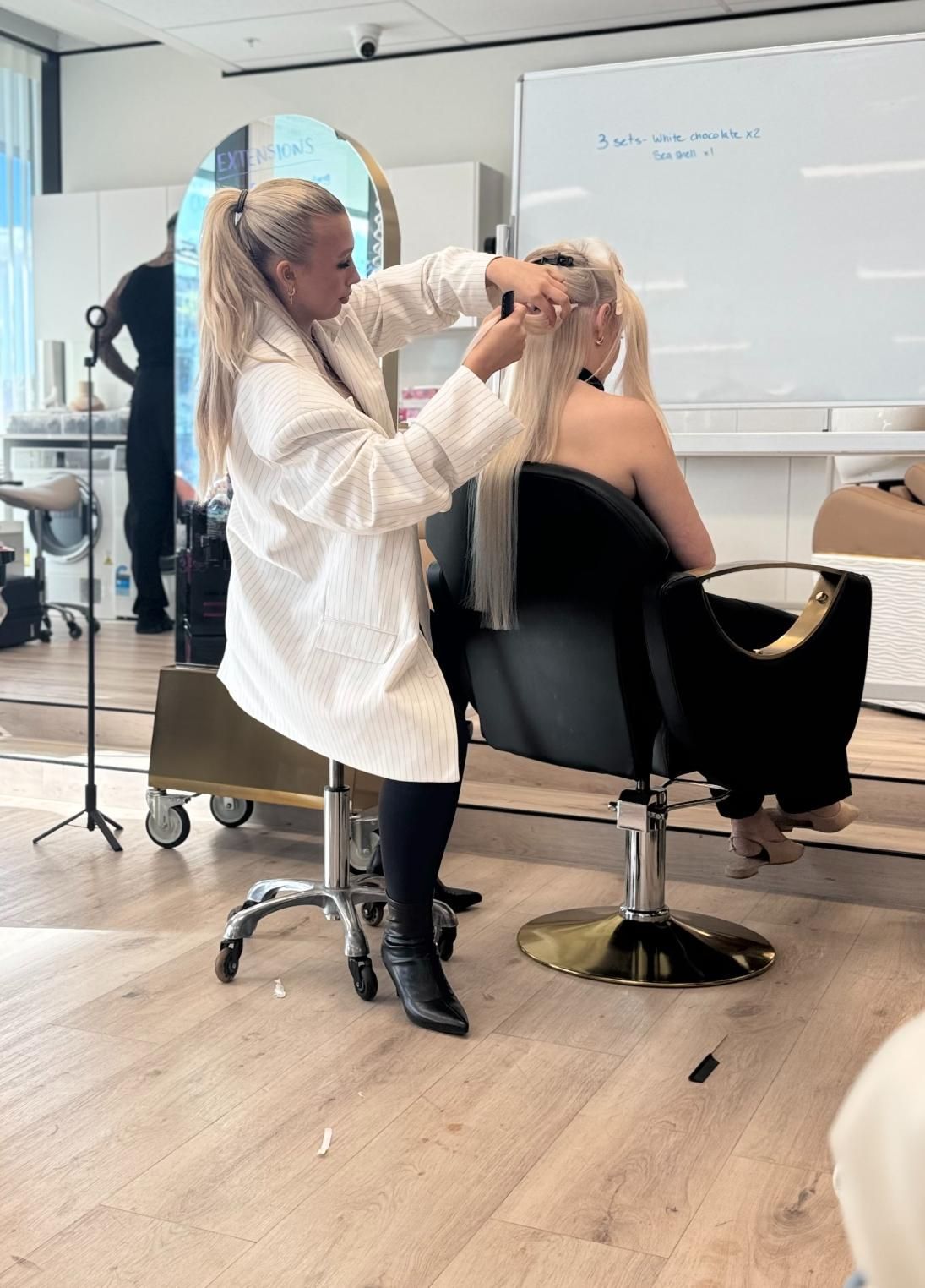 Blonde Woman Styling Another Blonde Woman's Hair in a Salon — Gina T Hair & Beauty In Mackay, QLD