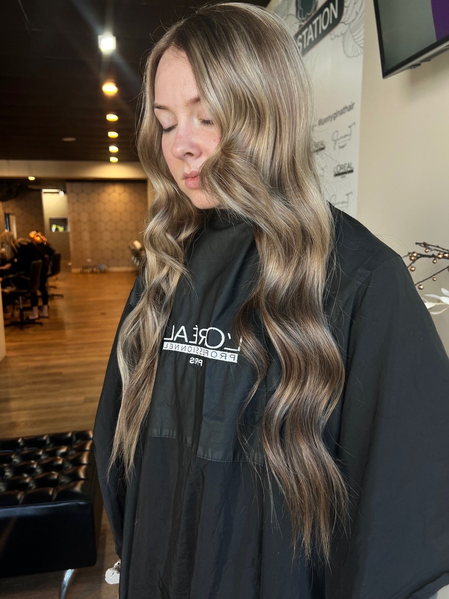 Woman With Long, Wavy, Light Blonde Hair. She Is In A Salon — Gina T Hair & Beauty In Mackay, QLD