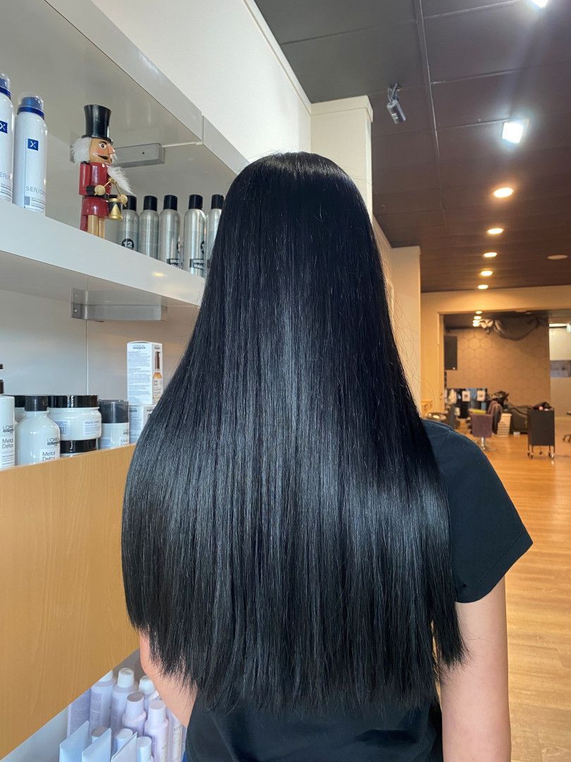Woman with long, shiny, black hair in a hair salon.— Gina T Hair & Beauty In Mackay, QLD
