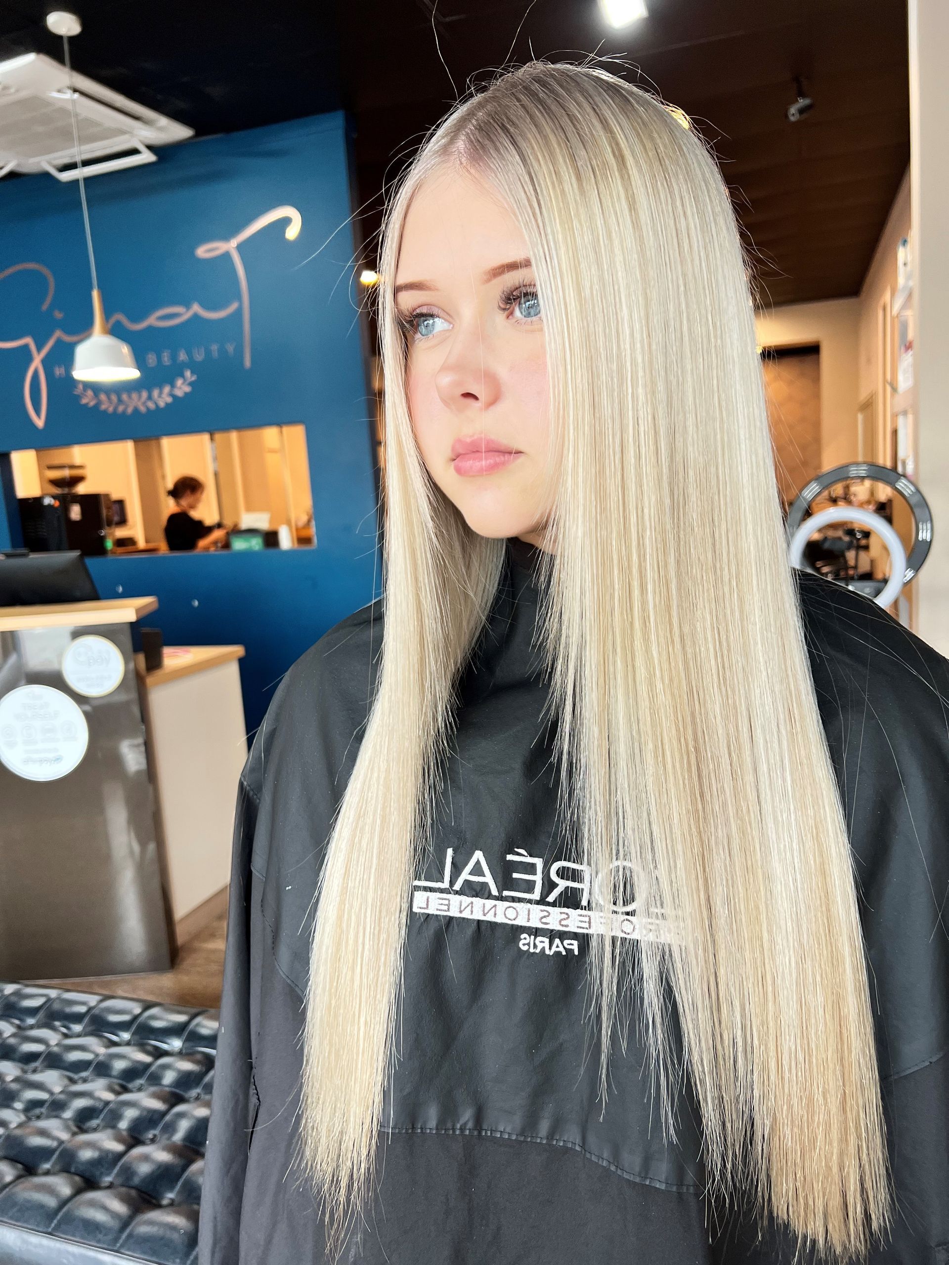 A Young Woman With Blonde Hair Styled Up With Loose Curls — Gina T Hair & Beauty In Mackay, QLD