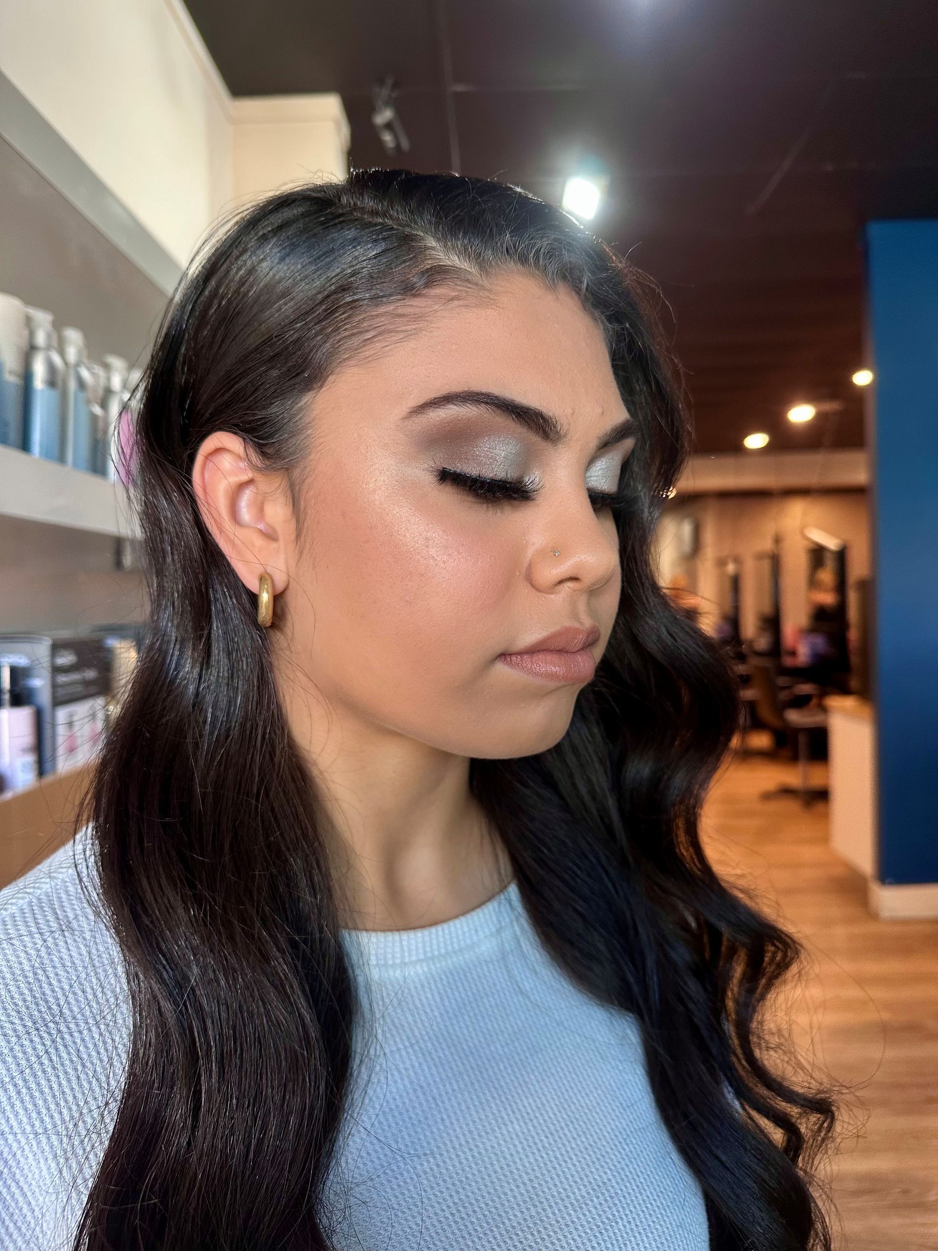 Makeup Artist Applying Eyeshadow To A Woman's Closed Eyes — Gina T Hair & Beauty In Mackay, QLD