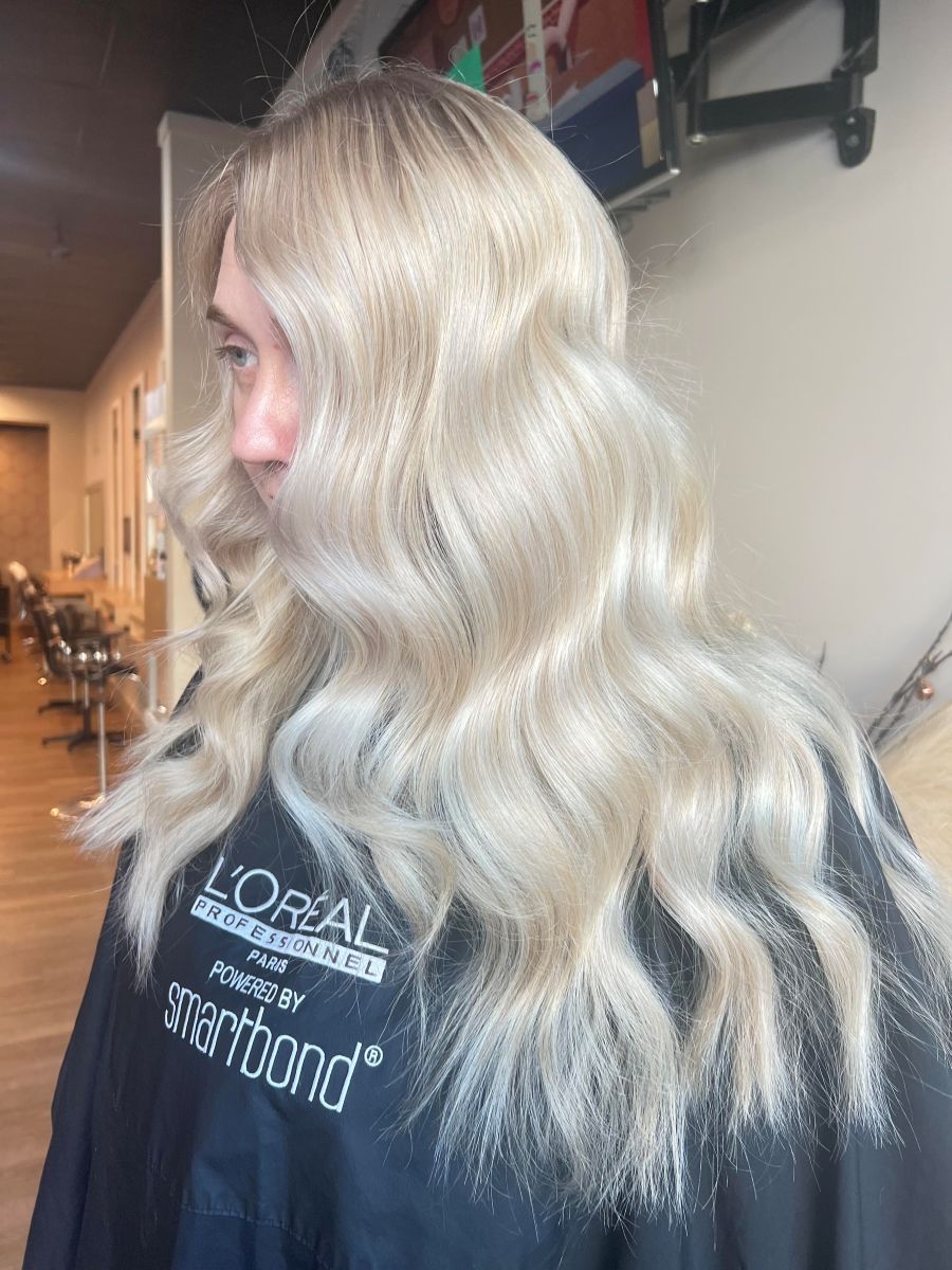 Woman With Long, Wavy, Platinum Blonde Hair In A Salon — Gina T Hair & Beauty In Mackay, QLD