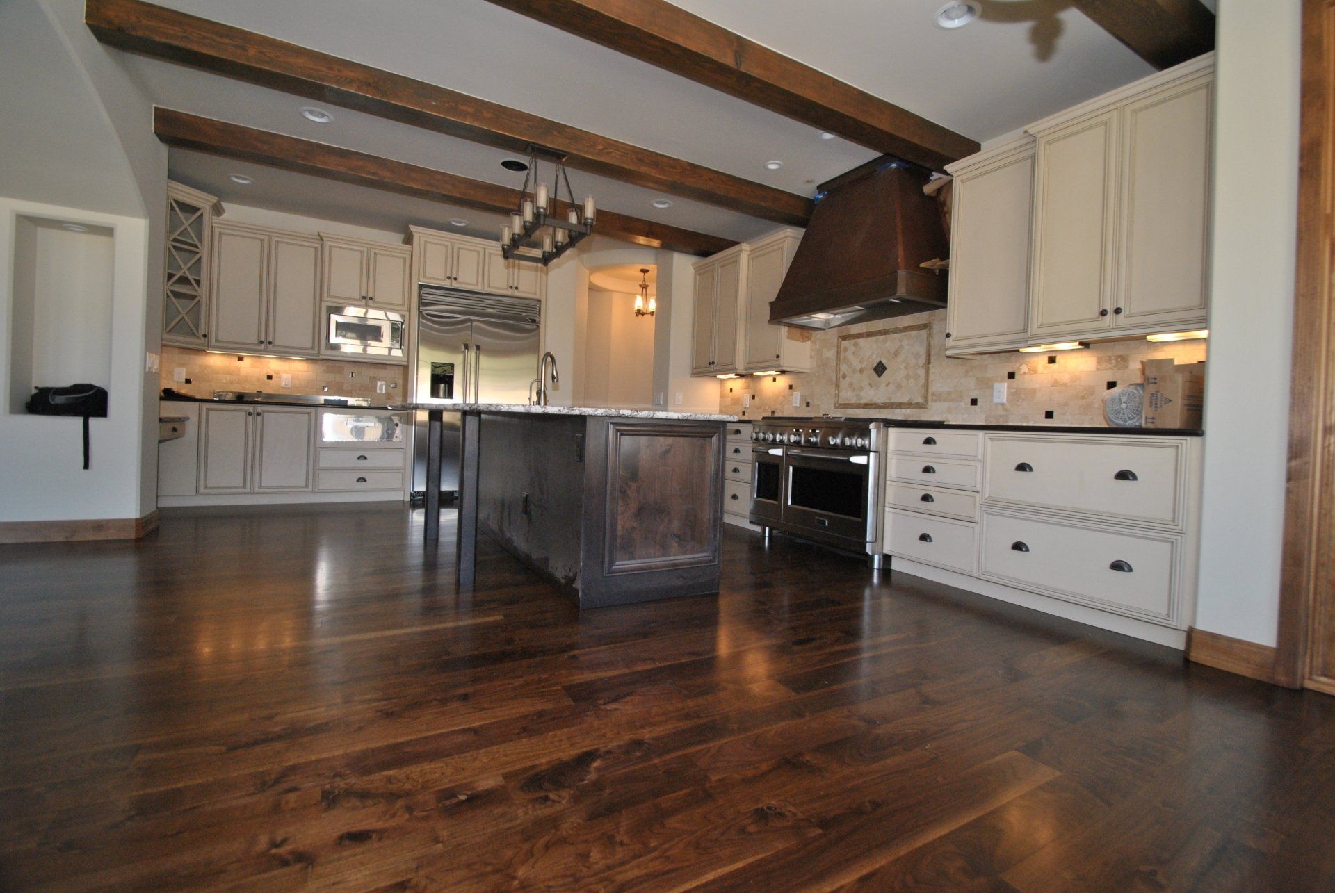 Kitchen with White Kitchen Cabinets and Wooden Floor — Denver, CO — All City Floor Co