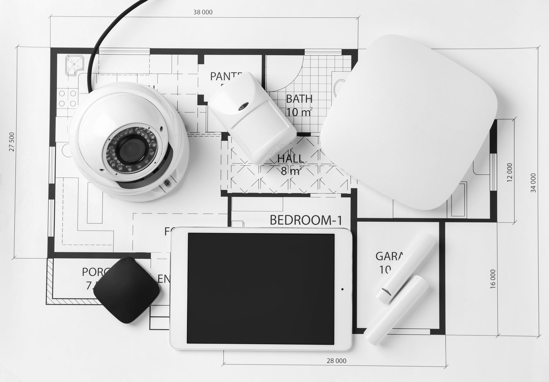 Home security devices and tablet placed on a residential floor plan layout. Home security devices and tablet placed on a residential floor plan layout.