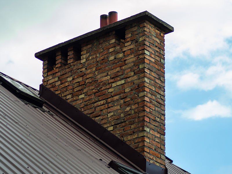 Chimney on a Roof — Parma, OH — Brick by Brick