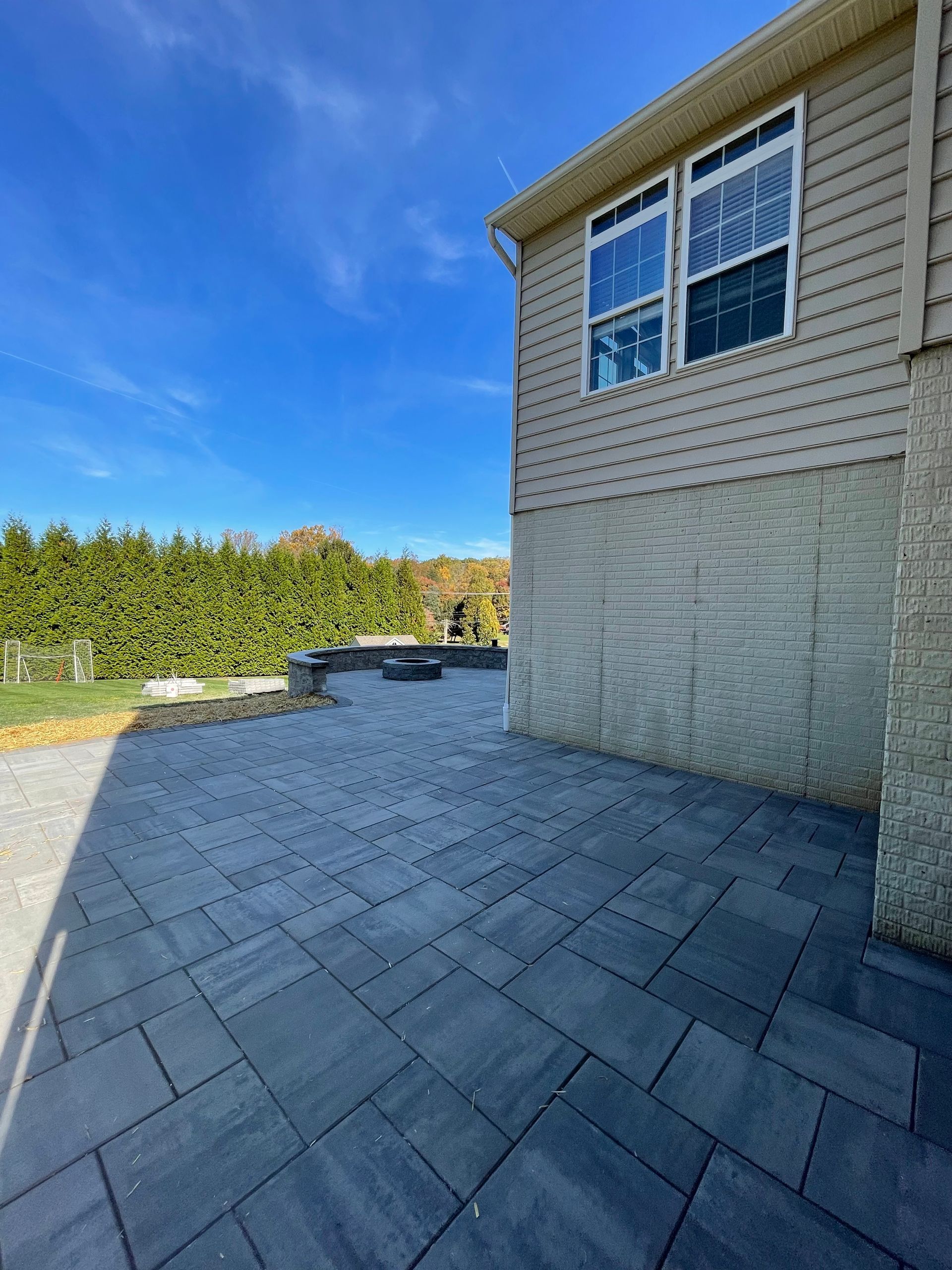 A large house with a patio in front of it.