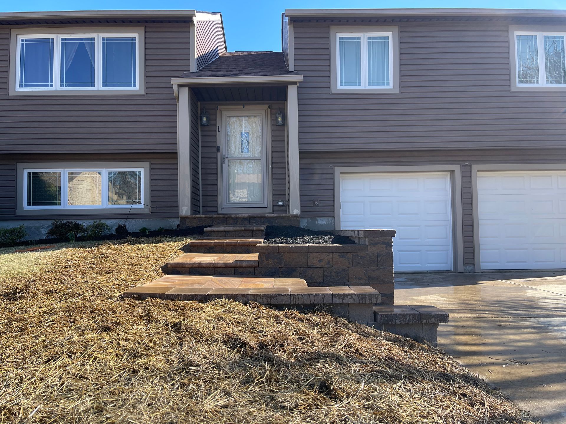 The front of a house with stairs leading up to it