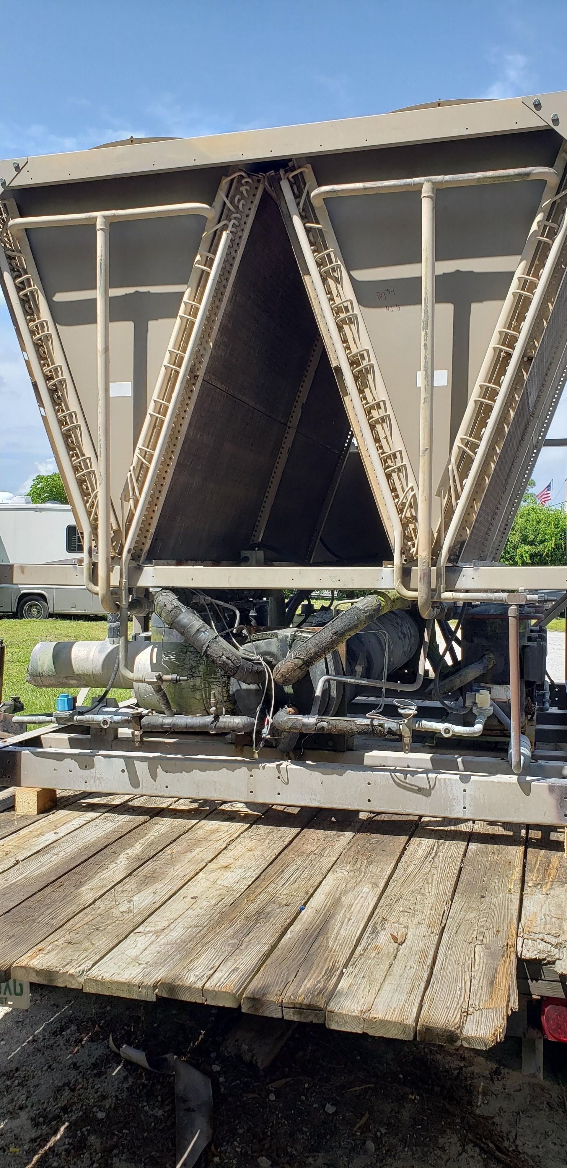 A large metal structure is sitting on top of a wooden platform.