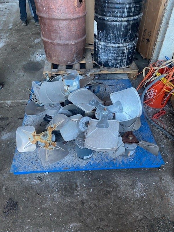 A bunch of fan blades are sitting on top of a blue table.