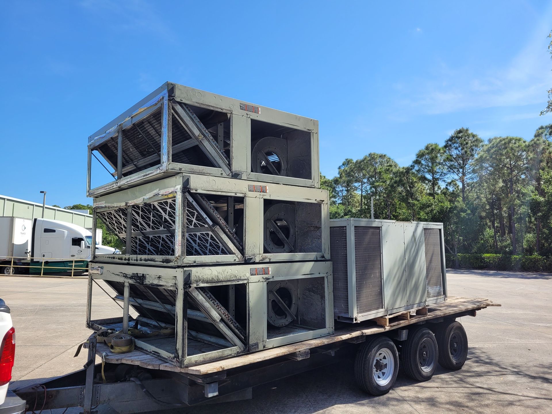 A trailer with a lot of boxes on it is parked in a parking lot.