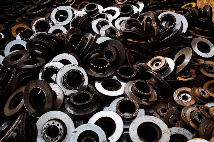 A pile of metal washers and nuts on a table.