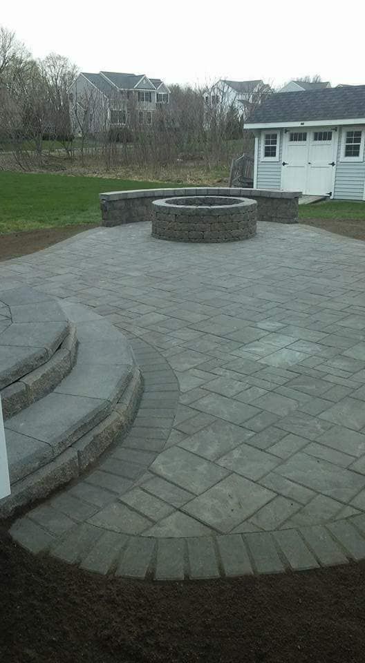 There is a fire pit in the middle of the patio.