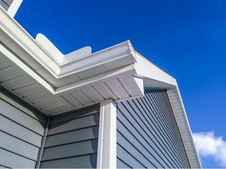 A close up of a gutter on a roof of a house.