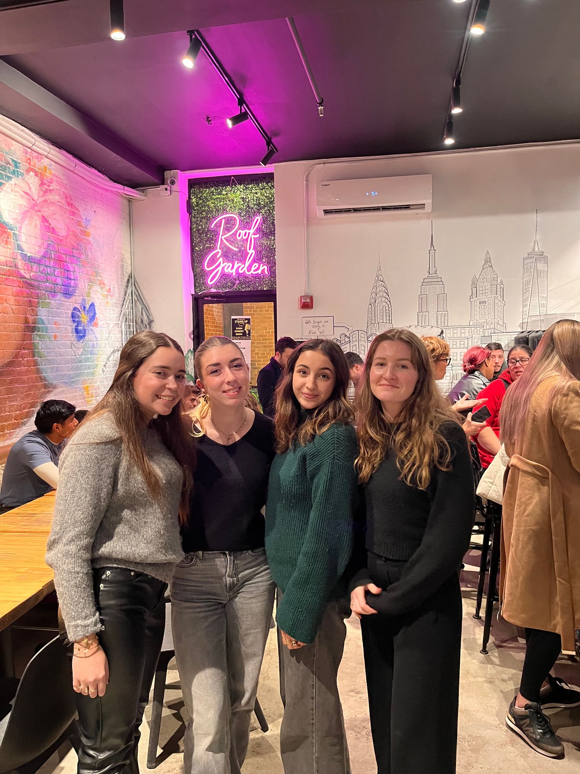 A group of young women are posing for a picture in a restaurant.