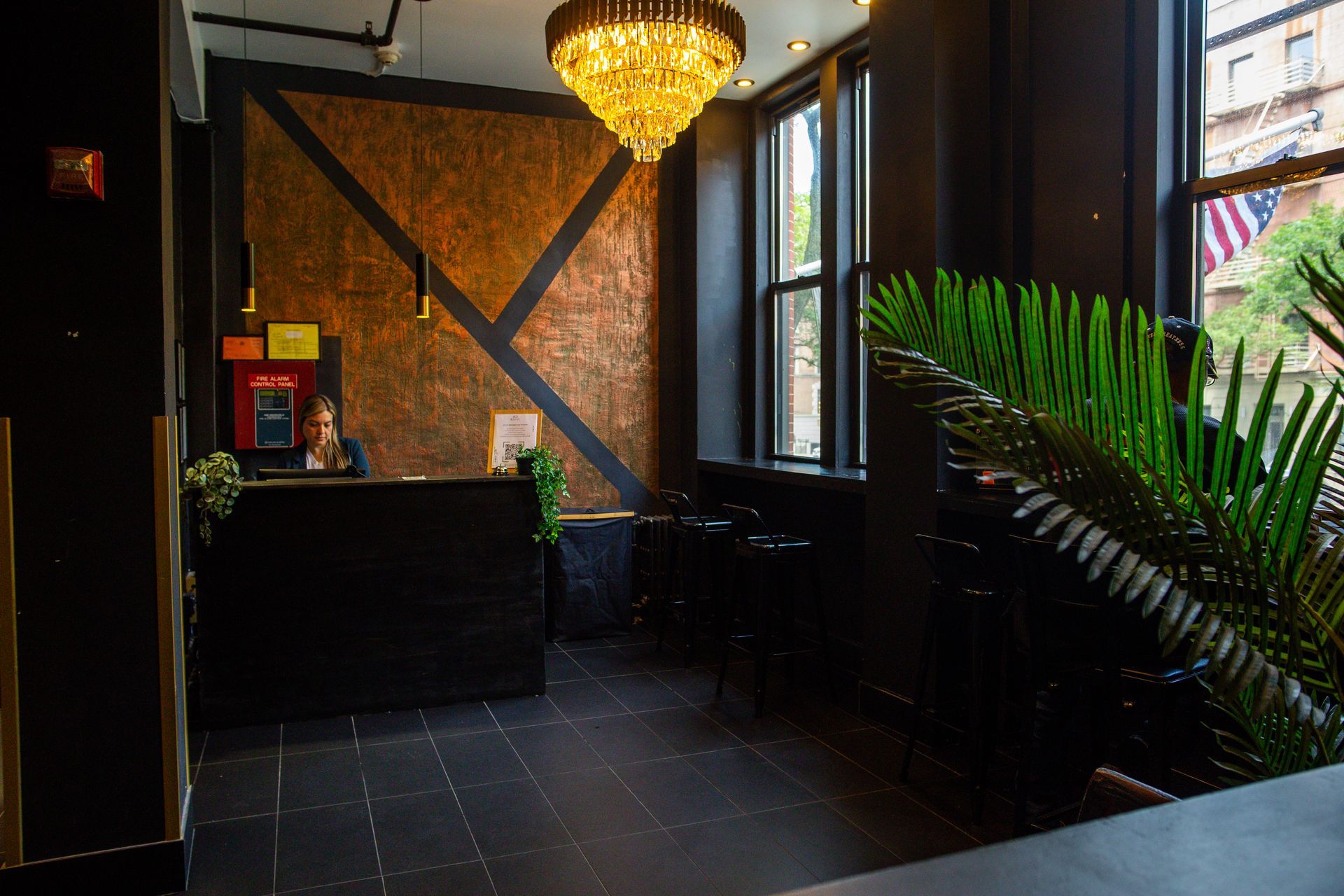 A reception area with a chandelier hanging from the ceiling.